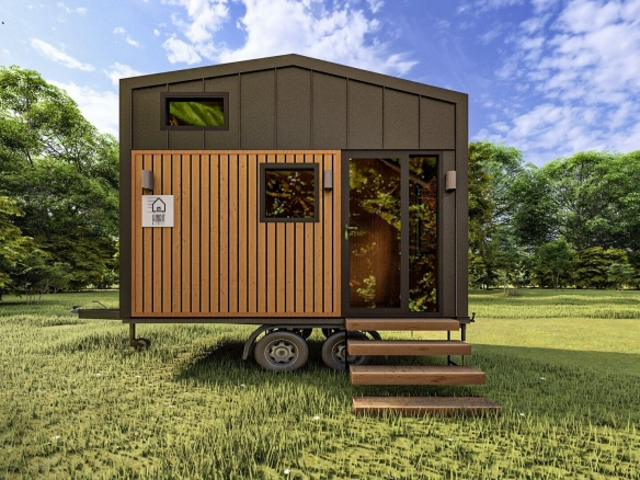 Ahşap kaplama ve siyah metal panellerle tasarlanmış tiny house’un giriş köşesi, yeşillikler içinde. Title: Giriş Köşesi – Modern Tiny House